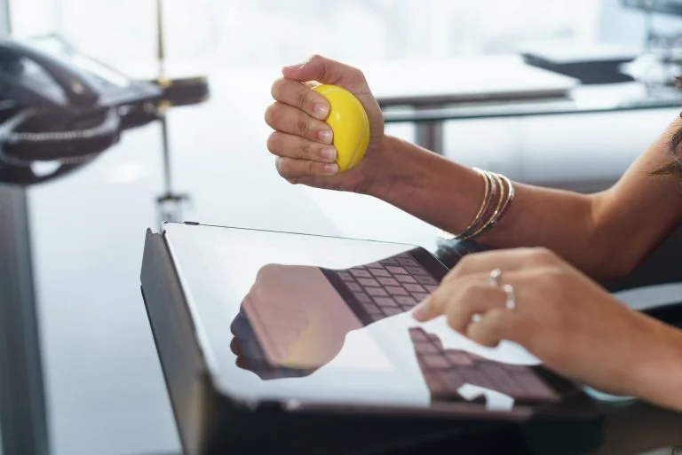 Stressed Office Worker With Anti Stress Ball Types Email